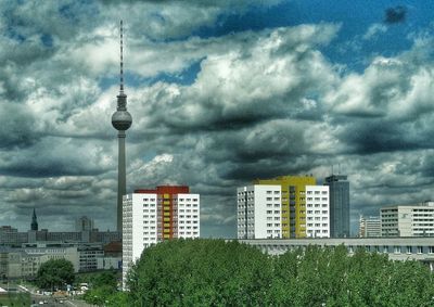 Buildings against cloudy sky