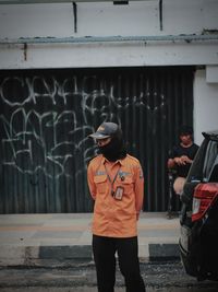 Full length of man standing on road in city