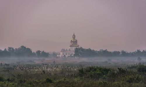 View of building against sky during foggy weather