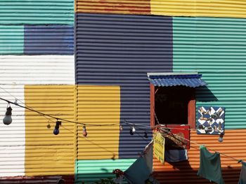 Multi colored umbrellas hanging against wall