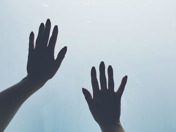 Close-up of hands against clear sky
