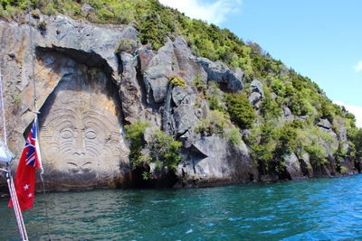 Rock formations by sea against sky