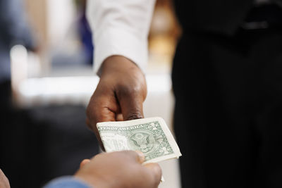 Midsection of businessman using mobile phone