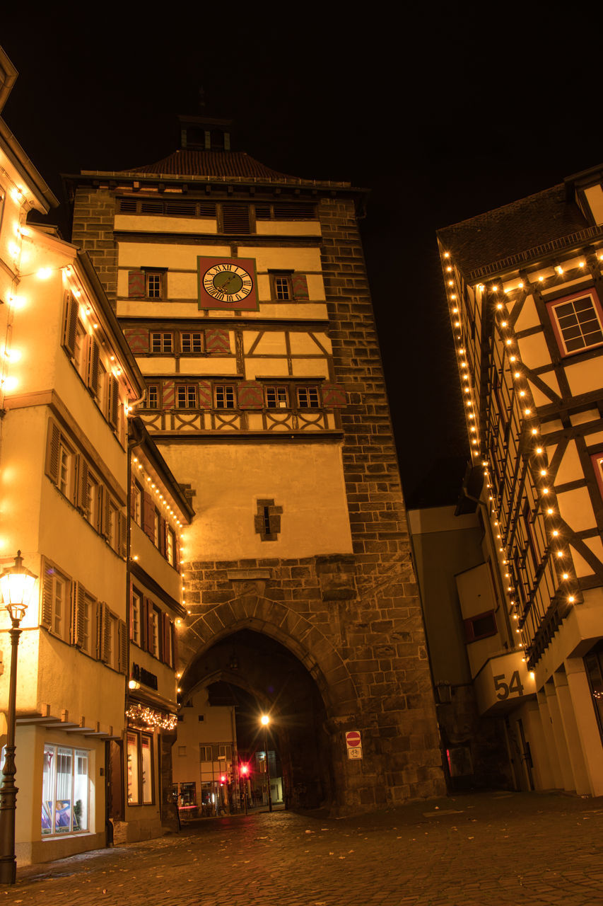 LOW ANGLE VIEW OF ILLUMINATED BUILDINGS IN CITY