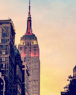 View of buildings against cloudy sky during sunset
