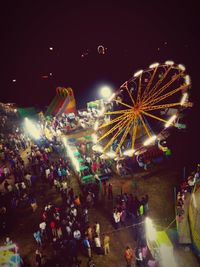 Illuminated ferris wheel in amusement park