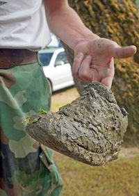 Close-up of man holding leaf