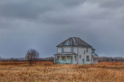 House on field against sky