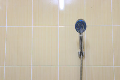 Close-up of ball on tiled floor against wall at home