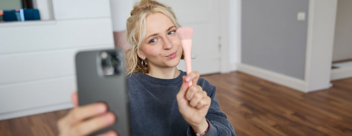 Portrait of young woman using mobile phone