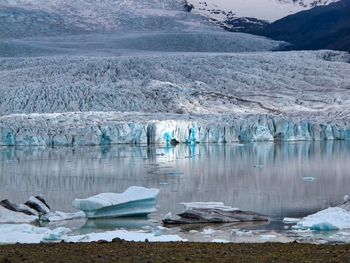 Scenic view of icebergs in lake during winter