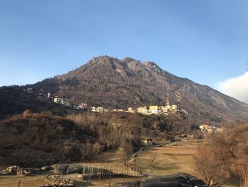 Scenic view of landscape and mountains against clear sky