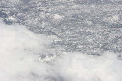 Aerial view of snowcapped mountains against sky