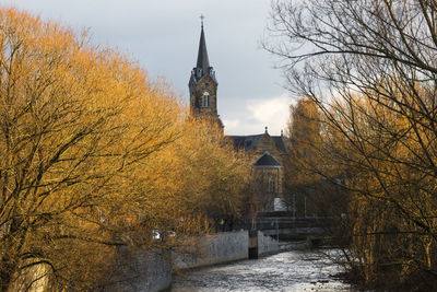 Panoramic view of trees and buildings against sky