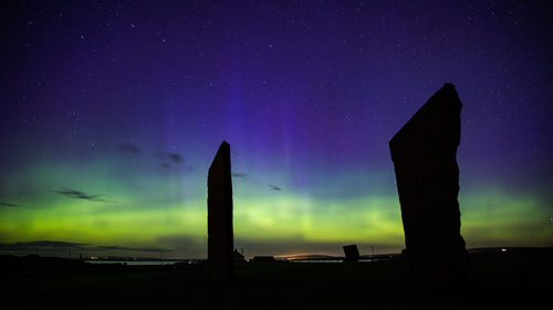 Northern lights with stones of stenness, orkney islands, uk. 