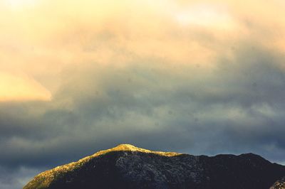 Low angle view of mountain against dramatic sky
