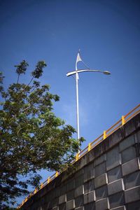 Low angle view of windmill against clear blue sky