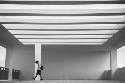 Full length side view of a man walking on wall