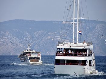 Ship sailing on sea against sky