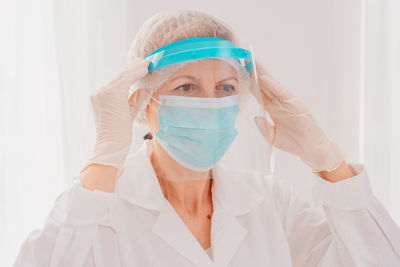 Close-up of tired doctor standing at hospital