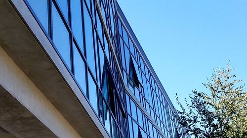 Low angle view of building against clear blue sky