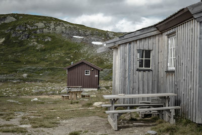 Wooden hut on skandinavian highland against mountain range 