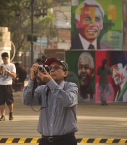 People photographing on street in city