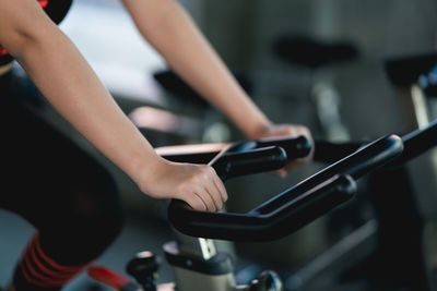 Midsection of woman exercising in gym