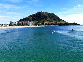 Scenic view of sea and mountains against sky