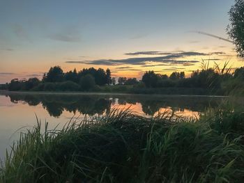 Scenic view of lake against sky during sunset