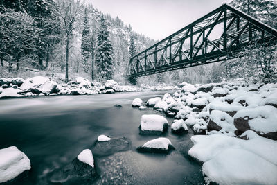 Bridge over river during winter