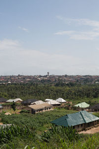 Houses on field against sky