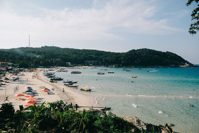 High angle view of boats on sea shore against sky