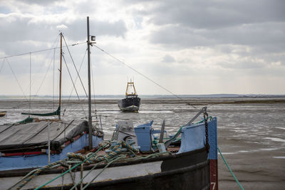 Fisherman boats stuck on the beach in low tide period in leigh-on-sea, uk.