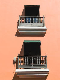 Beautiful orange wall with balconies from apartments in puerto rico san juan