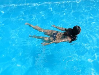 High angle view of woman swimming in pool