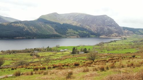 Scenic view of lake against cloudy sky