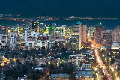 Aerial view of illuminated buildings in city at night