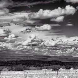 Scenic view of landscape against cloudy sky