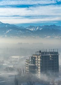 Scenic view of buildings in city against sky