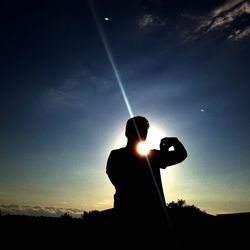 Silhouette man standing against sky