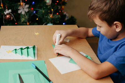 Boy drawing on table