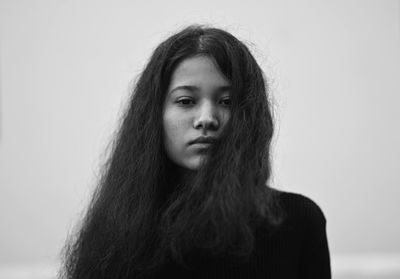 Portrait of a beautiful young woman over white background