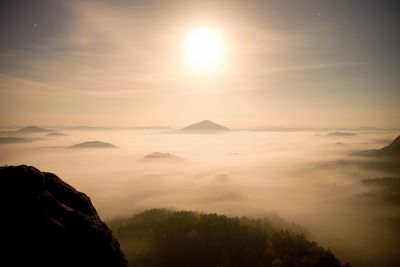 Full moon night with sunrise in a beautiful mountain park.  sandstone peaks and hills in night