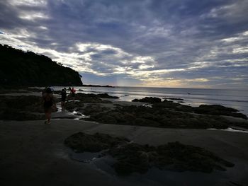 Man standing on beach against sky