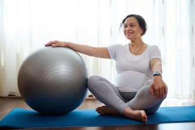 Young woman exercising in gym