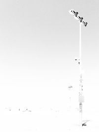 Low angle view of birds flying against clear sky