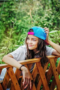 Smiling young woman sitting outdoors