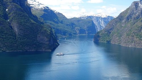 Scenic view of sea and mountains against sky