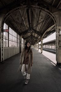 Portrait of woman standing on bridge